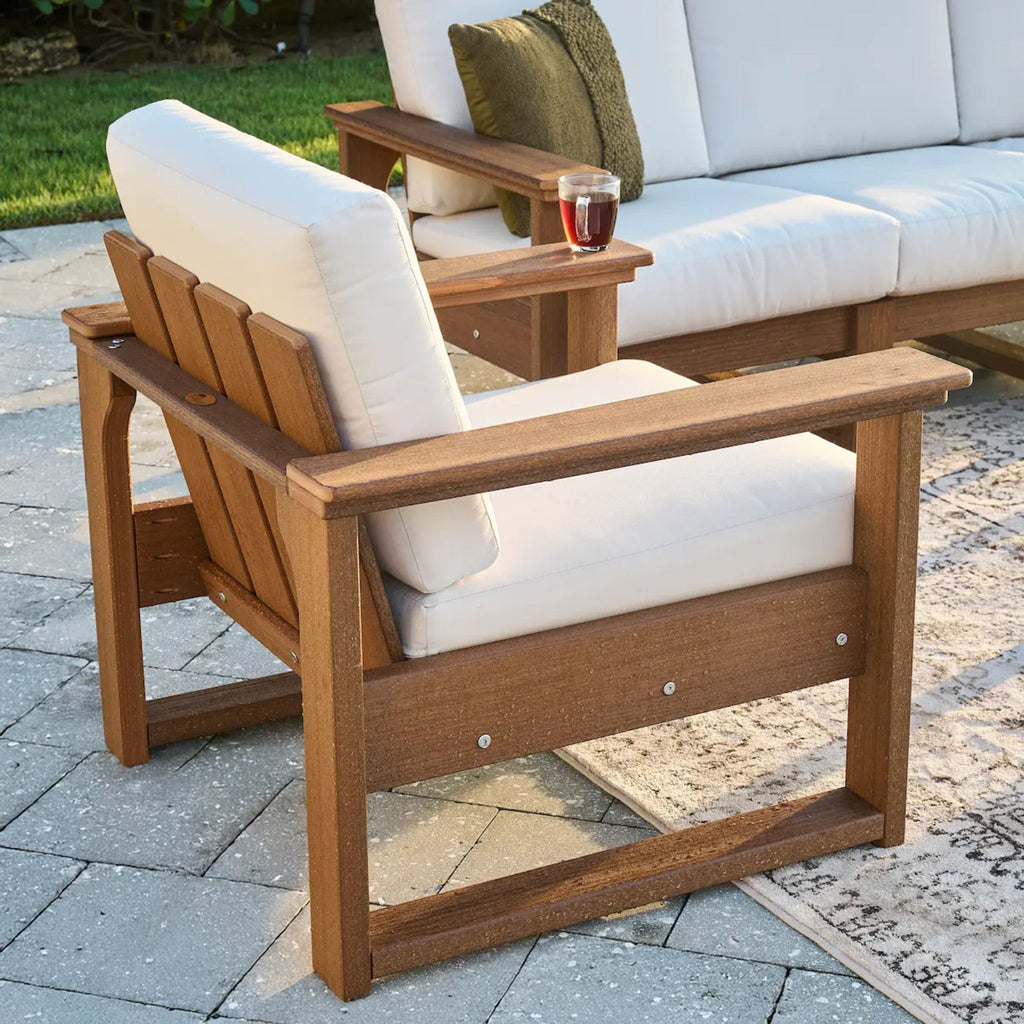 Wooden outdoor chair with white cushion on a patio