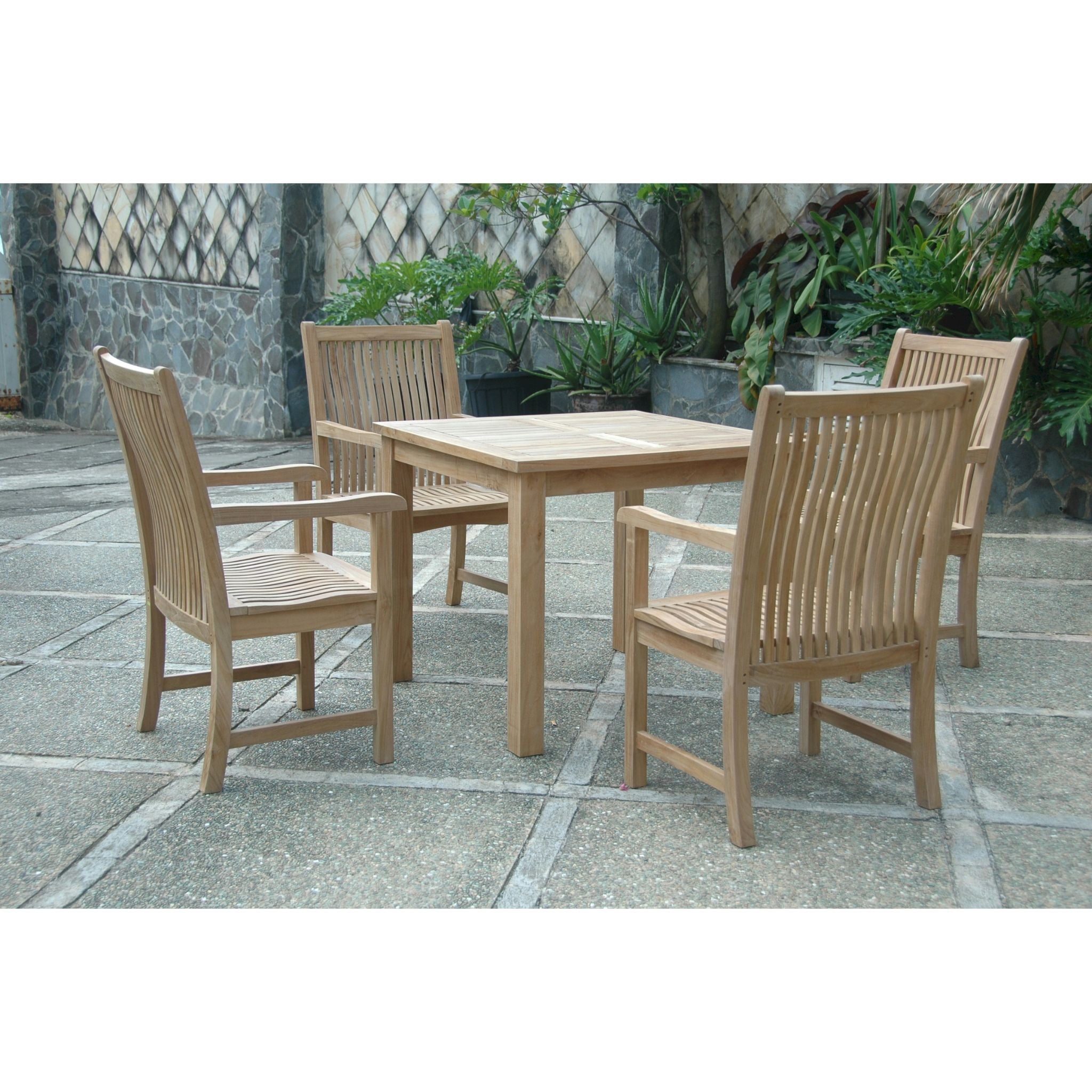 A 5-piece outdoor teak dining set including a square table and four armchairs, shown on a stone patio with potted plants in the background.