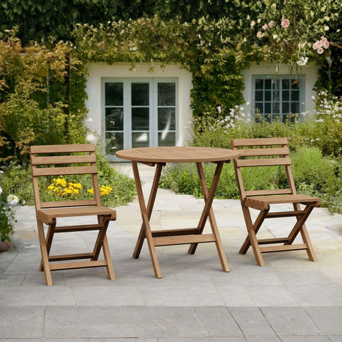 Wooden outdoor table and chairs set on a patio with a garden background