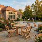 Outdoor patio with wooden table and chairs, basketball hoop, and people playing basketball.