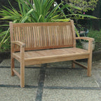 Wooden bench in a garden setting with plants in the background