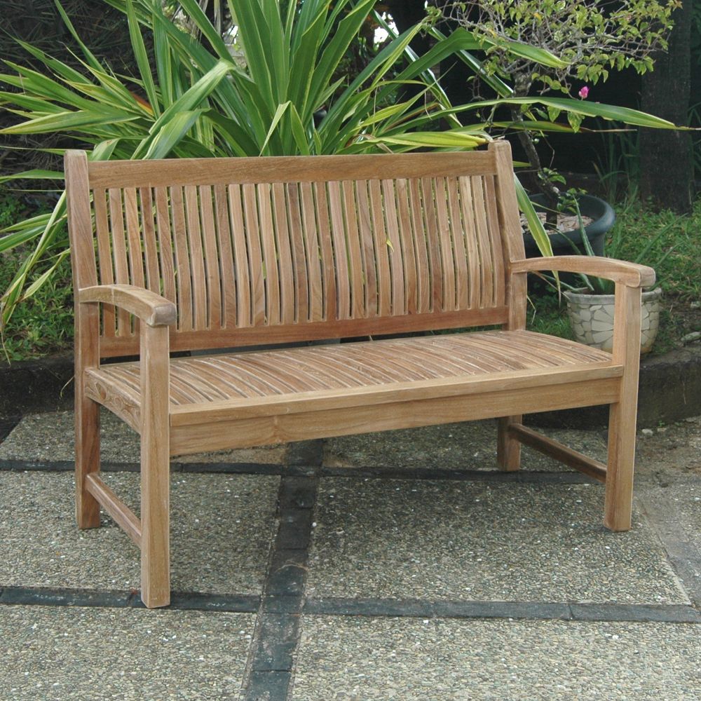 Wooden bench in a garden setting with plants in the background