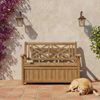 A wooden outdoor storage bench with a slatted backrest and front panel, placed on a terracotta tile patio against a stucco wall. A golden retriever lies at the bench's right side, and purple flowers and greenery frame the scene.