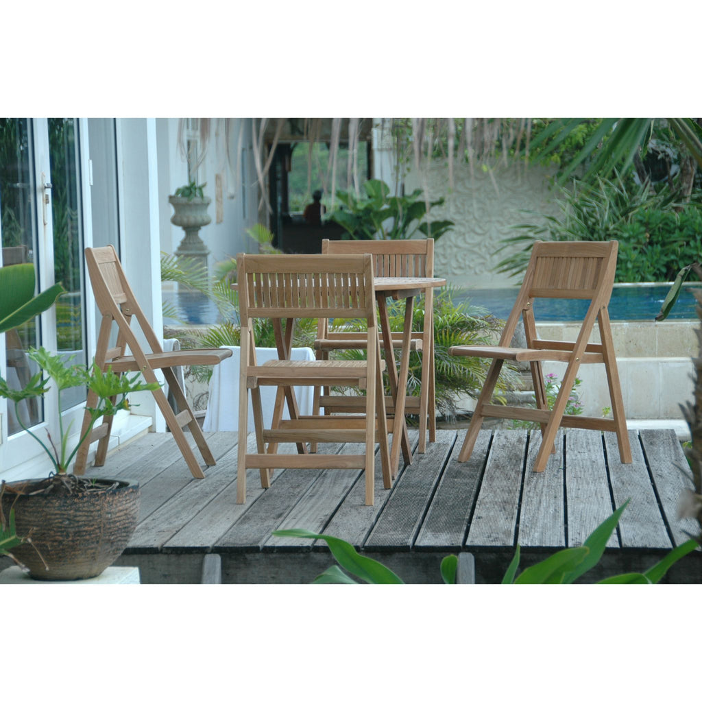Wooden outdoor furniture set on a wooden deck with plants and a pool in the background.