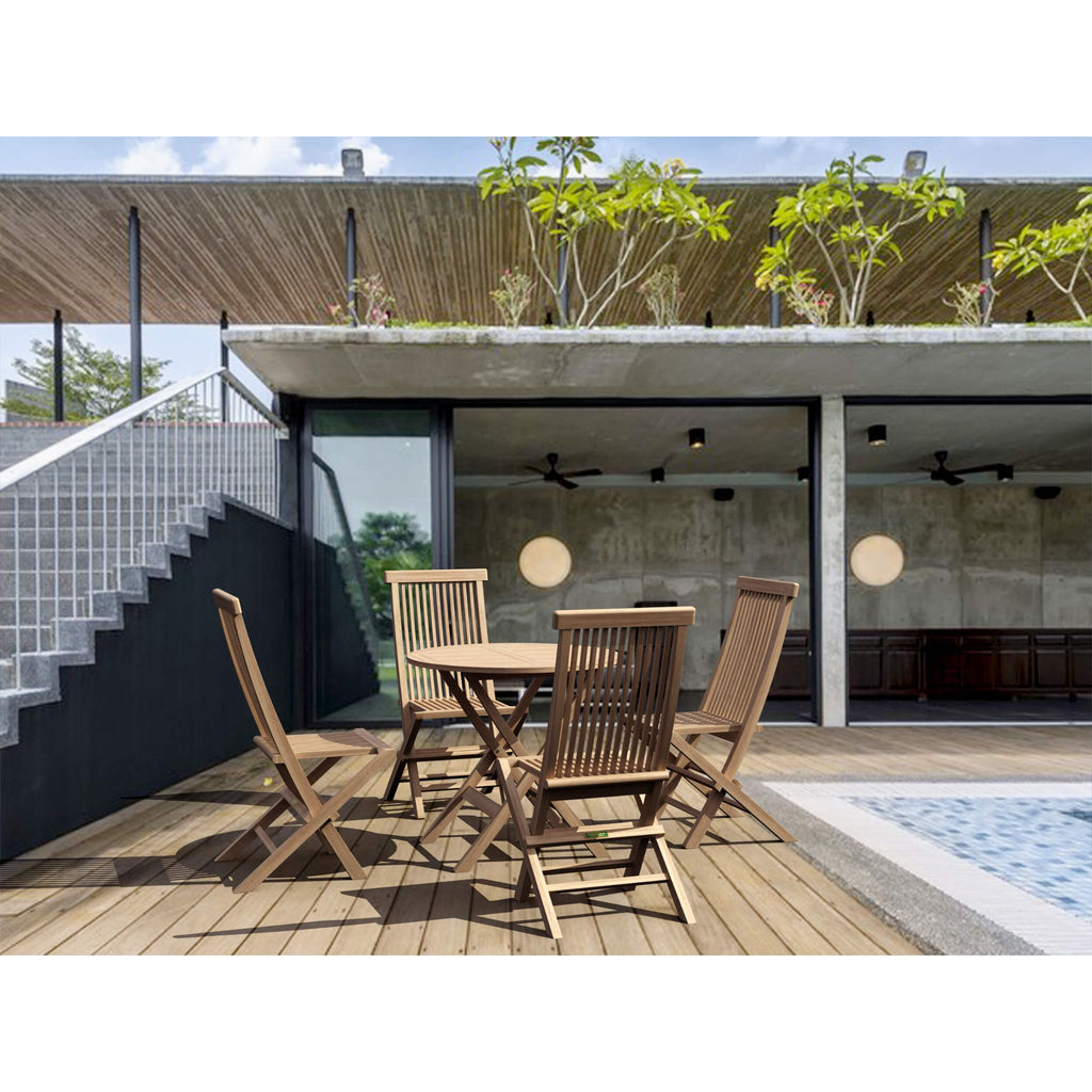 A wooden outdoor dining set with a slatted table and four matching folding chairs placed on a wooden deck beside a pool, with a modern concrete and wood building in the background.