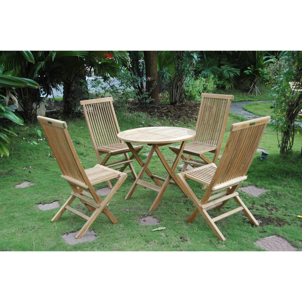 Wooden outdoor table and chairs set on a grassy area with trees in the background
