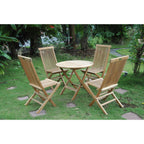 Wooden outdoor table and chairs set on a grassy area with trees in the background