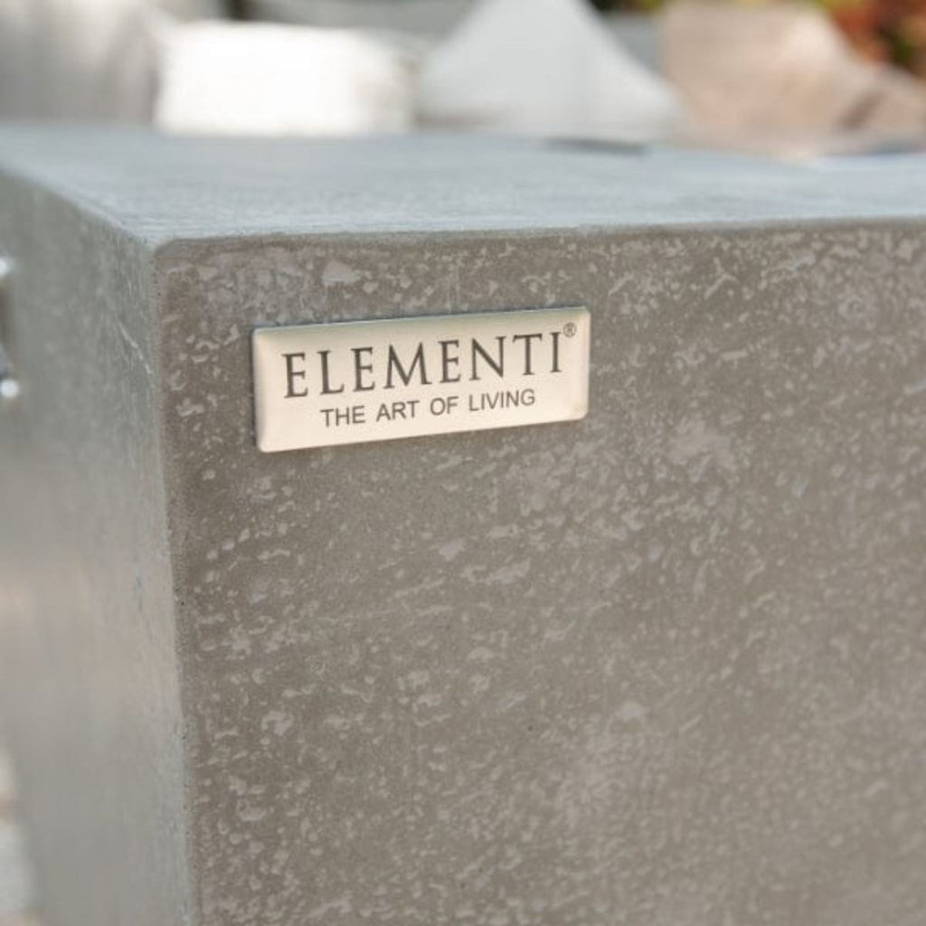 Close-up of a textured concrete block with 'Elementi' branding.