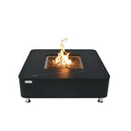 A square black outdoor fire pit table with a visible flame, set against a plain white background.