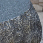 Close-up of a textured stone surface with a blurred background