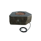 Hexagonal stone fire pit table with a dark textured base, filled with brown decorative stones, shown on a white background with its power cord visible.
