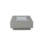 A square concrete fire pit table with a recessed glass wind guard, shown from a front-three-quarters angle on a solid white background.