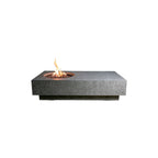 A rectangular gray stone fire pit table with a circular fire bowl and active flames, shown against a solid white background.