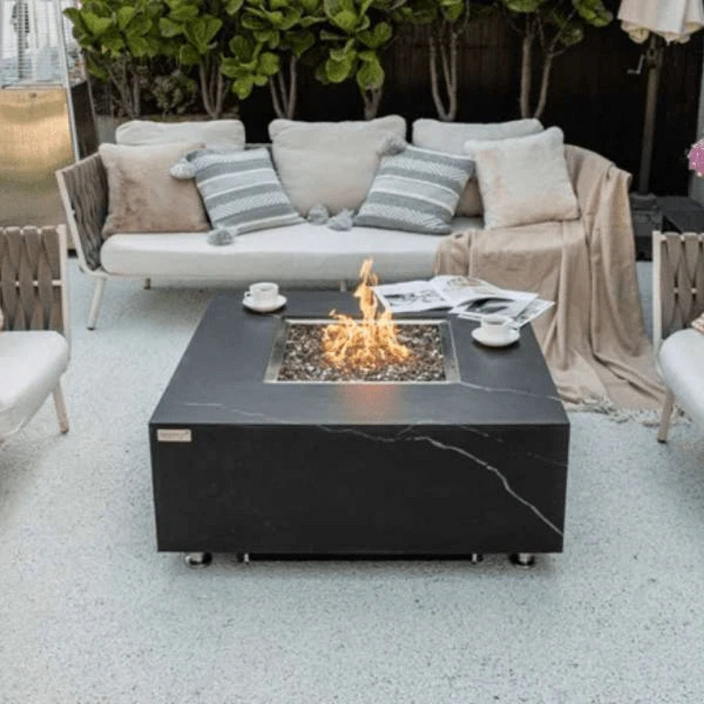 Outdoor patio setup with a fire pit table and seating area.