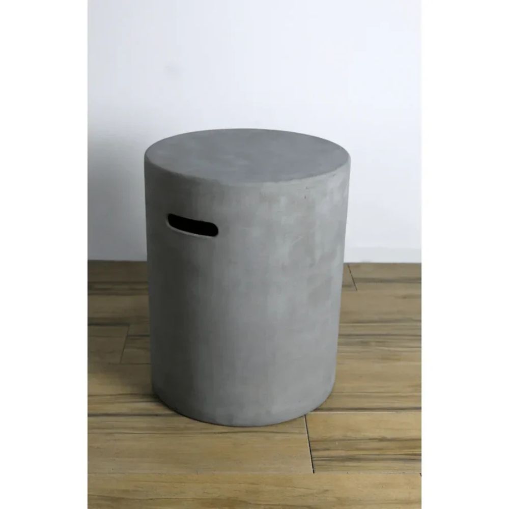 Concrete stool on a wooden floor with a white wall background
