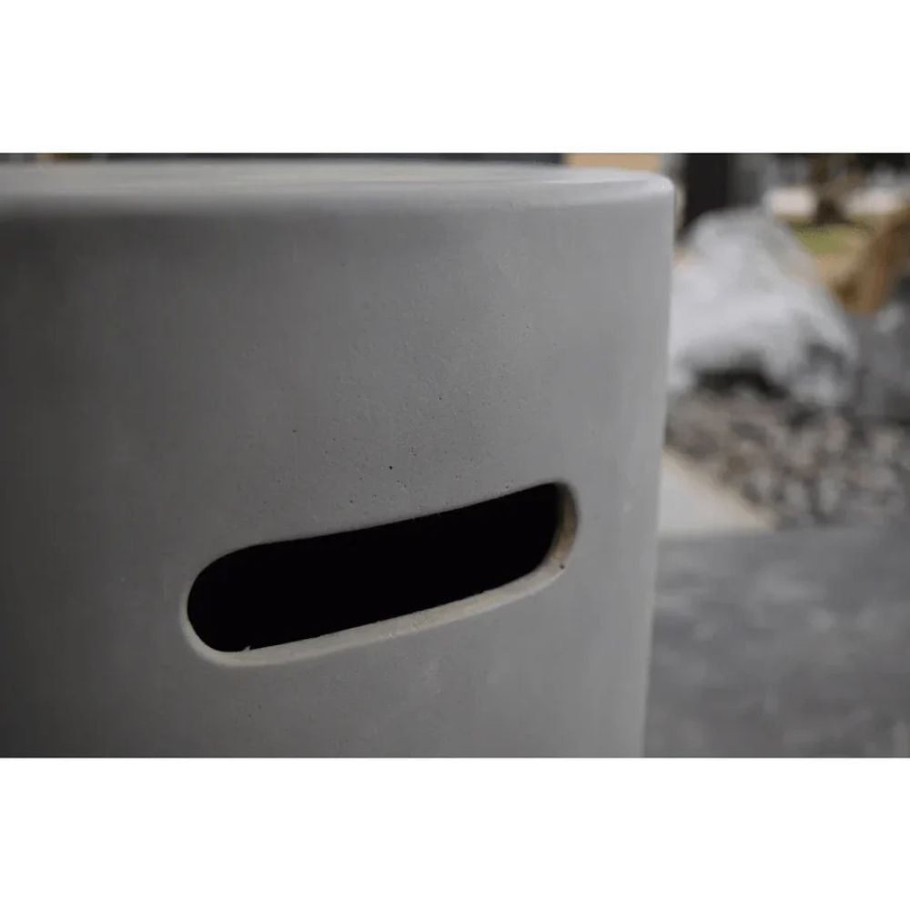 Close-up of a gray concrete block with a small hole, blurred background