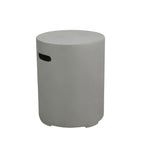 A minimalist cylindrical side stool in a light gray concrete finish, featuring a small black oval cutout on the side, set against a plain white background.