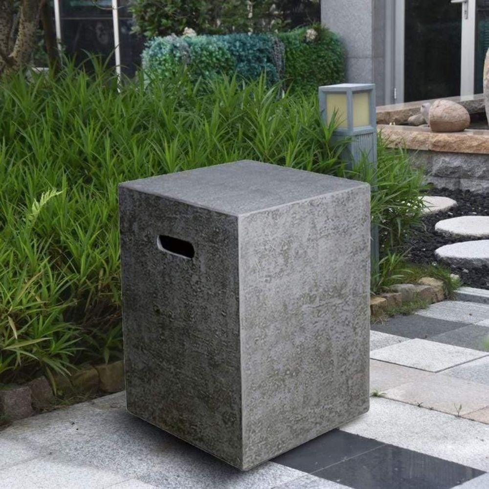 Concrete trash bin in a garden setting with greenery and a stone pathway.