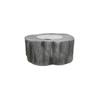 A round, rustic fire pit table designed to look like a weathered tree stump, featuring a textured gray bark pattern and a smooth, light gray circular firebox insert on top, shown against a plain white background.