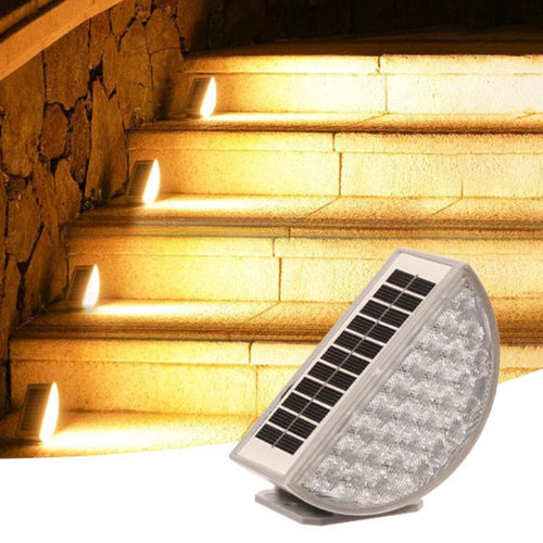 Solar-powered outdoor light fixture illuminating stone steps.