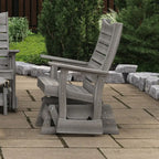 Gray wooden chair on a patio with greenery in the background