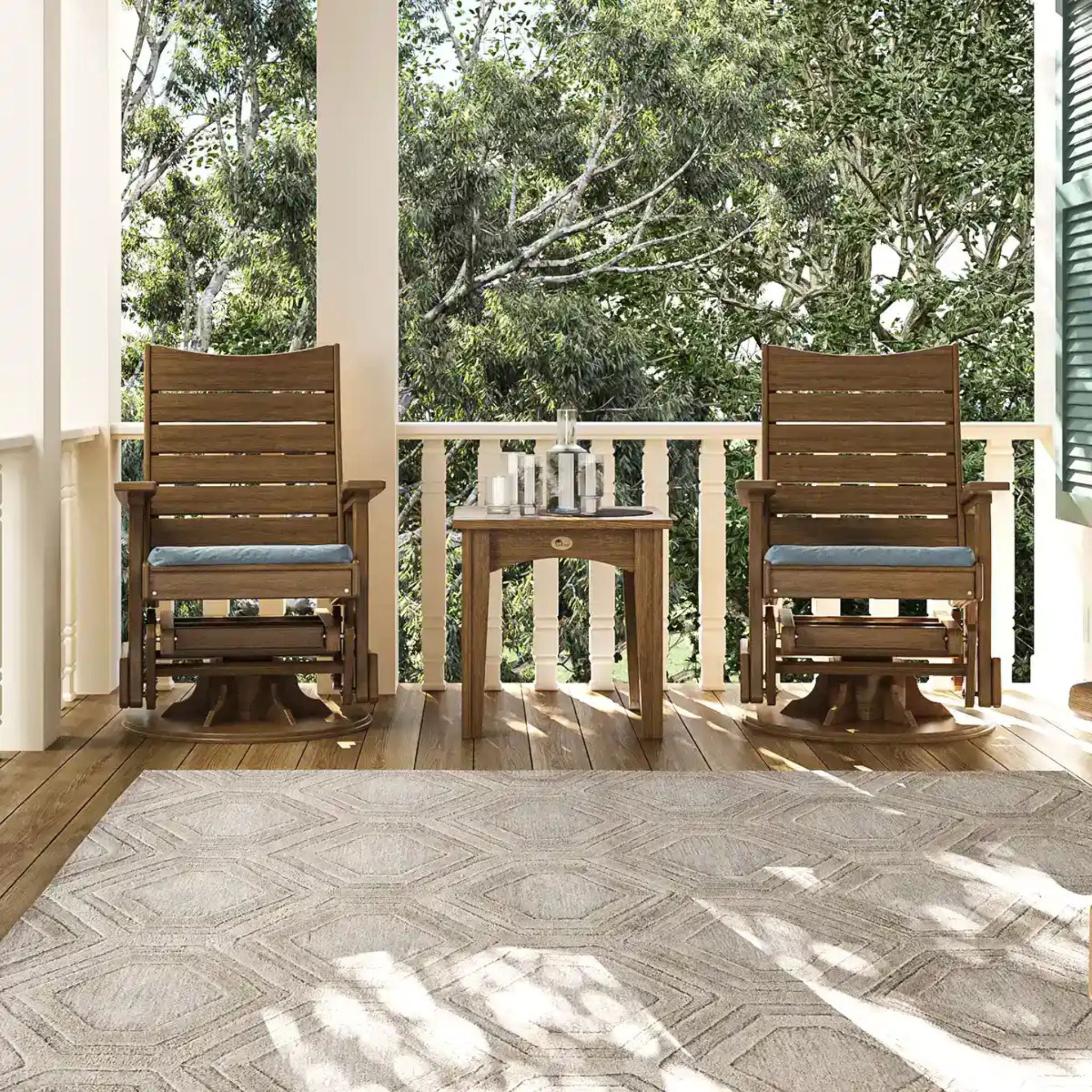 Wooden chairs and table on a porch with trees in the background