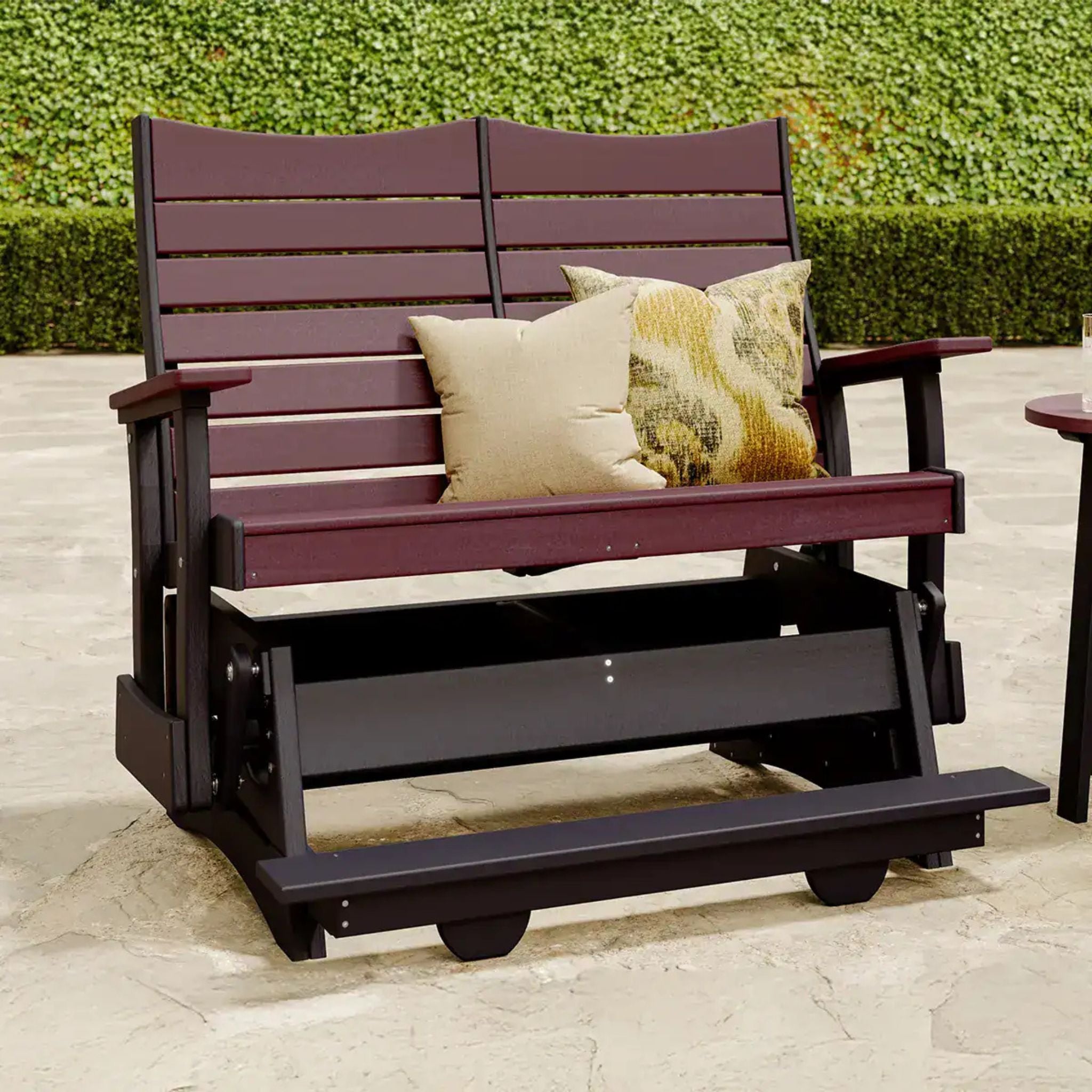 Wooden bench with cushions on a stone patio