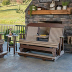 Wooden outdoor swing chair on a patio with stone wall and garden view