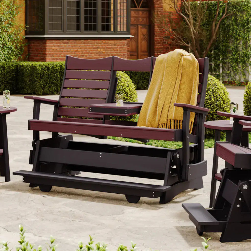 Wooden porch swing with a yellow blanket in an outdoor setting