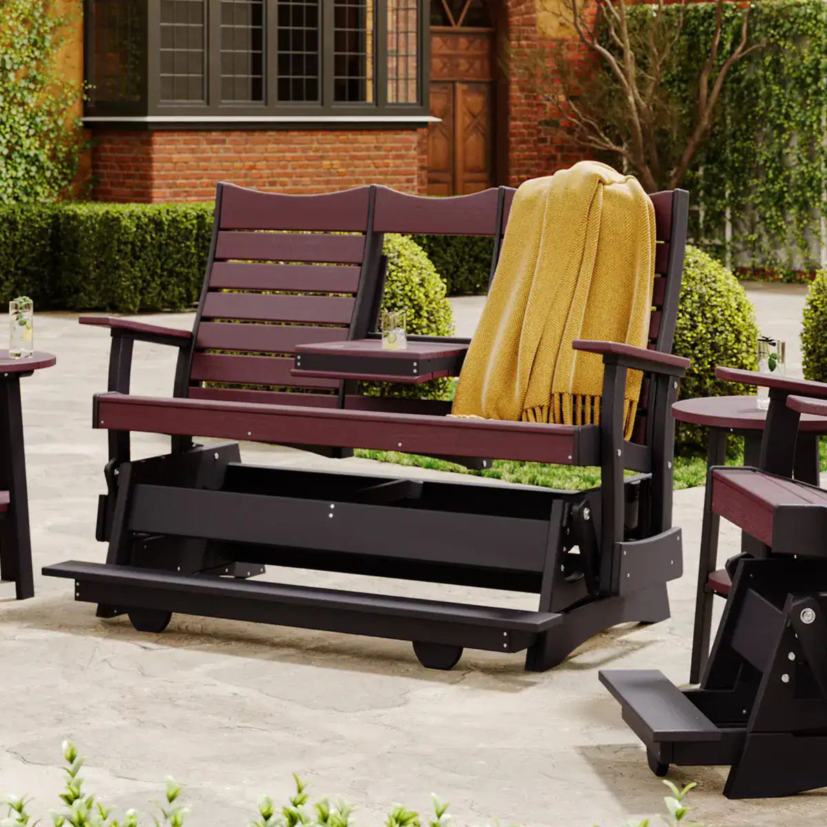 Wooden porch swing with a yellow blanket in an outdoor setting