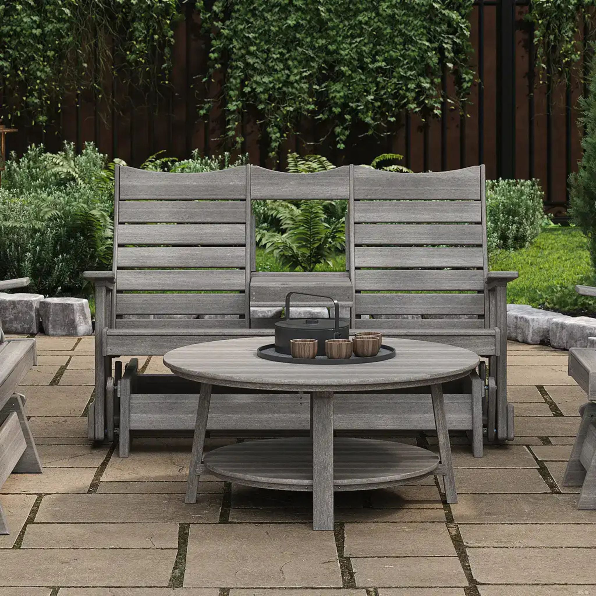 Gray outdoor furniture set with a round table and chairs on a patio.