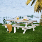 Picnic table with drinks and snacks by a body of water