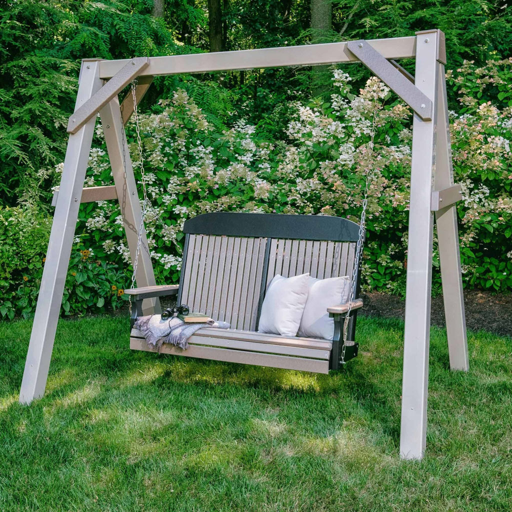 Wooden swing with white cushions in a garden setting