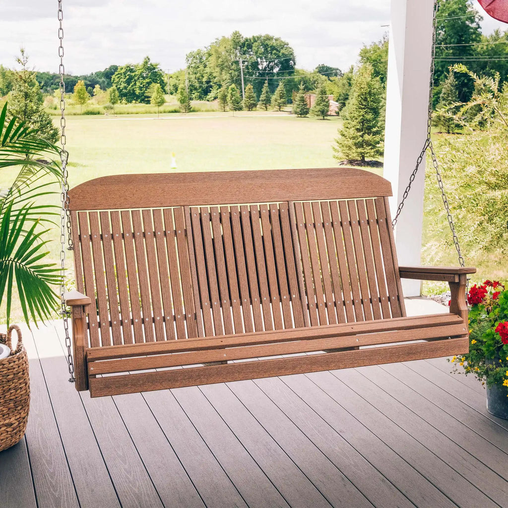 Wooden porch swing on a deck with a scenic background