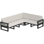 Sectional outdoor sofa with black frames and white cushions on a white background