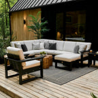Outdoor patio with sectional sofa, chairs, and coffee table on a wooden deck.