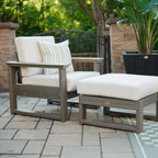 Outdoor patio furniture set with cushions on a paved patio