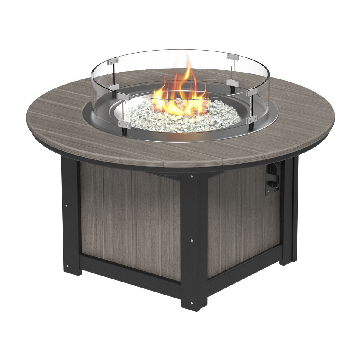 Round outdoor fire pit table with a gray wood-look top, dark metal frame, glass wind guard, and glowing fire with white stones inside, shown on a plain white background.