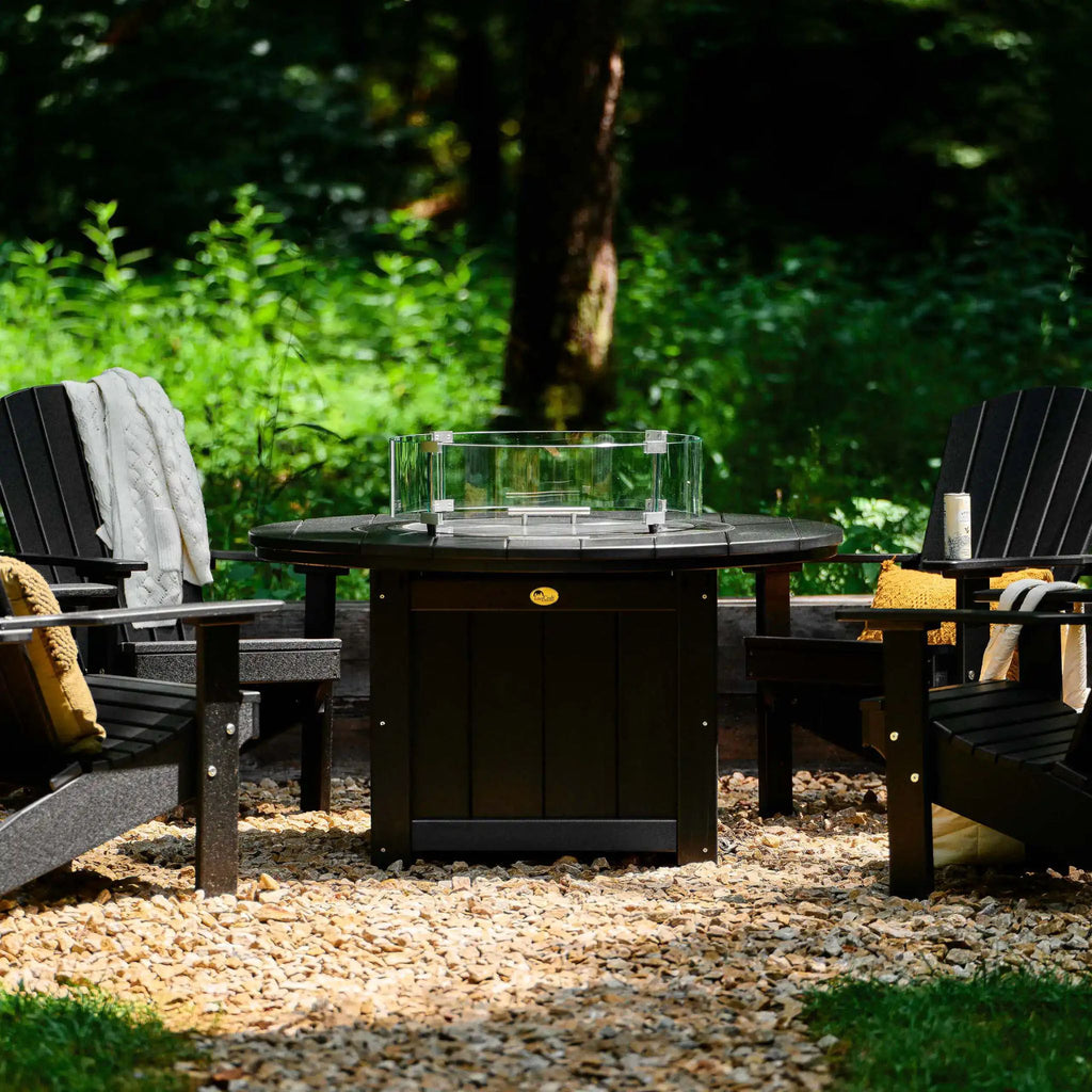 Outdoor setting with a fire pit table and Adirondack chairs in a garden.