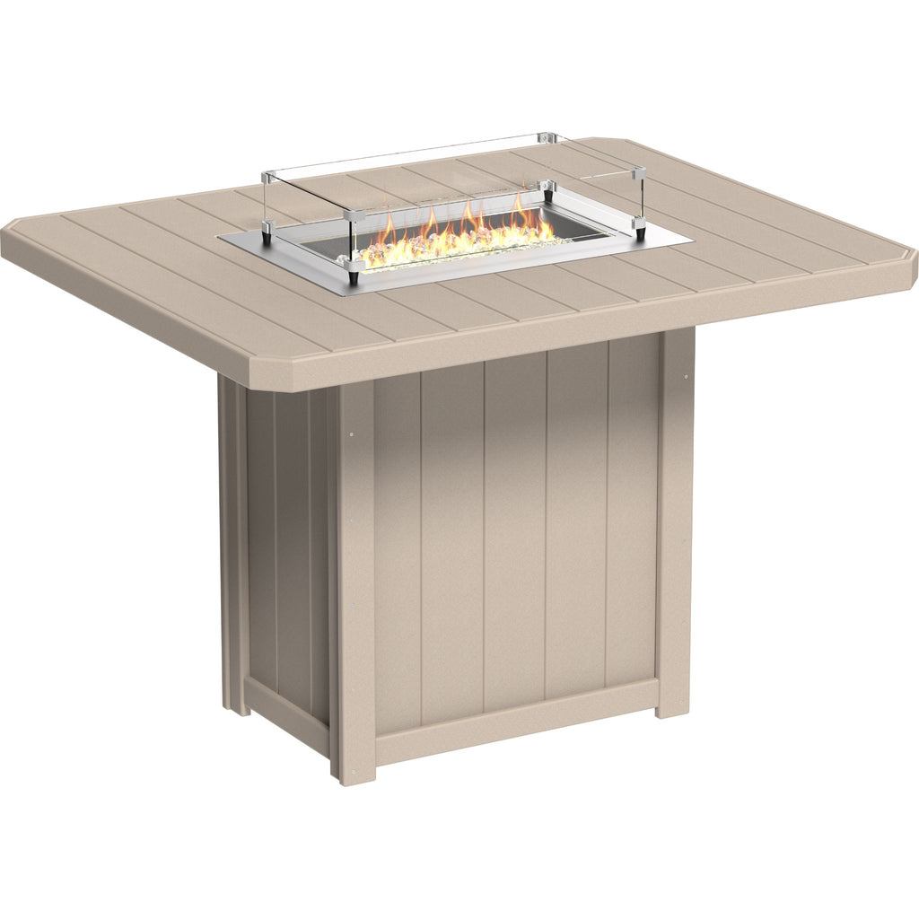 A square outdoor fire pit table in a warm beige/sand color, featuring a built-in rectangular firebox with visible flames and a clear protective glass wind guard.