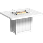 A white outdoor fire pit table with a square slatted top, a built-in firebox with visible flames, and a clear glass wind guard, shown on a plain white background.