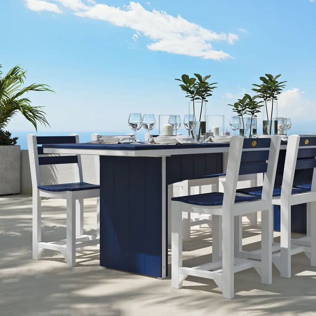 Outdoor dining set with blue table and white chairs on a sunny day.