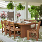 Wooden outdoor dining set with chairs and table in a garden setting