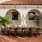 Outdoor dining area with a large table and chairs on a patio.