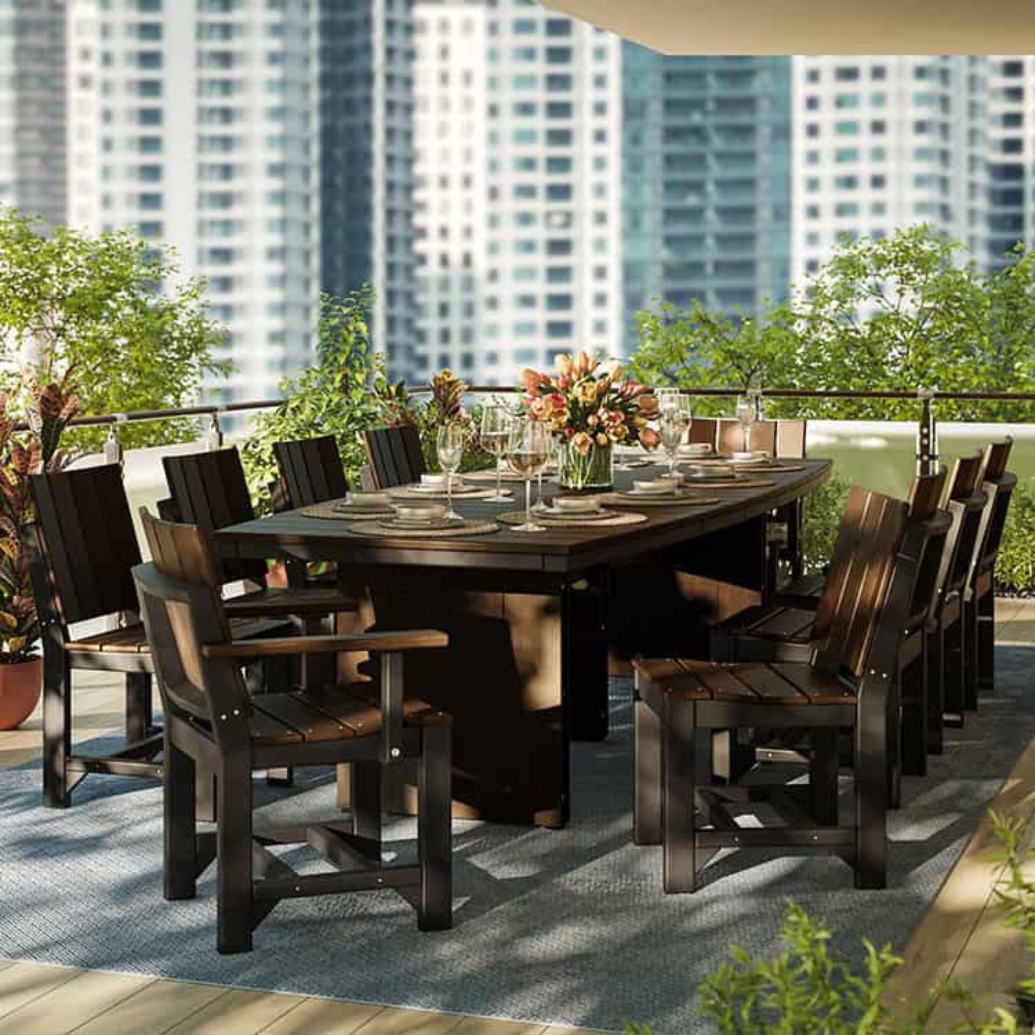 Dining table set with chairs on a rooftop with city skyline in the background