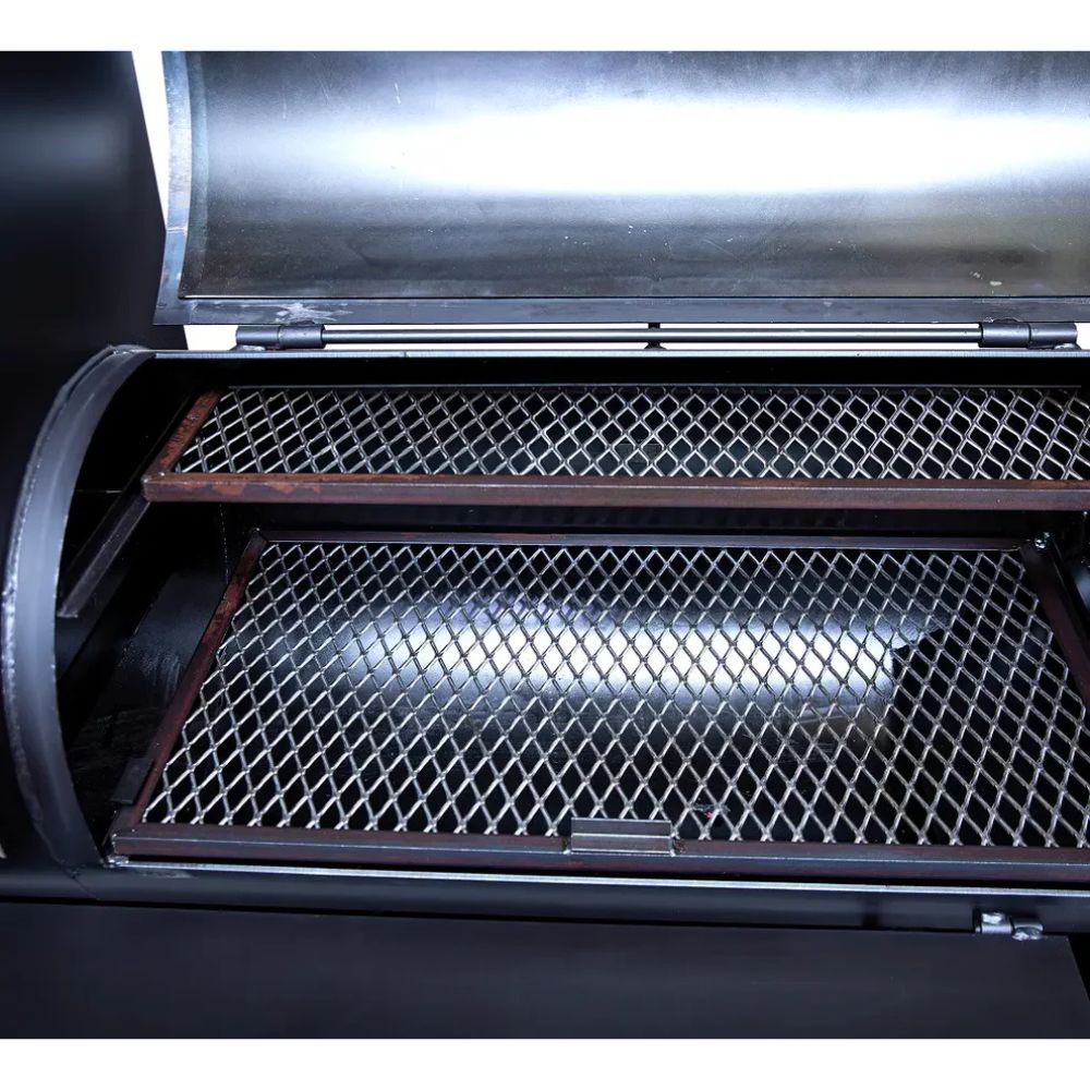 Close-up of a grill with open lid showing grates inside