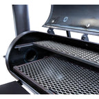 Close-up of a grill with open lid showing grates and smoke.