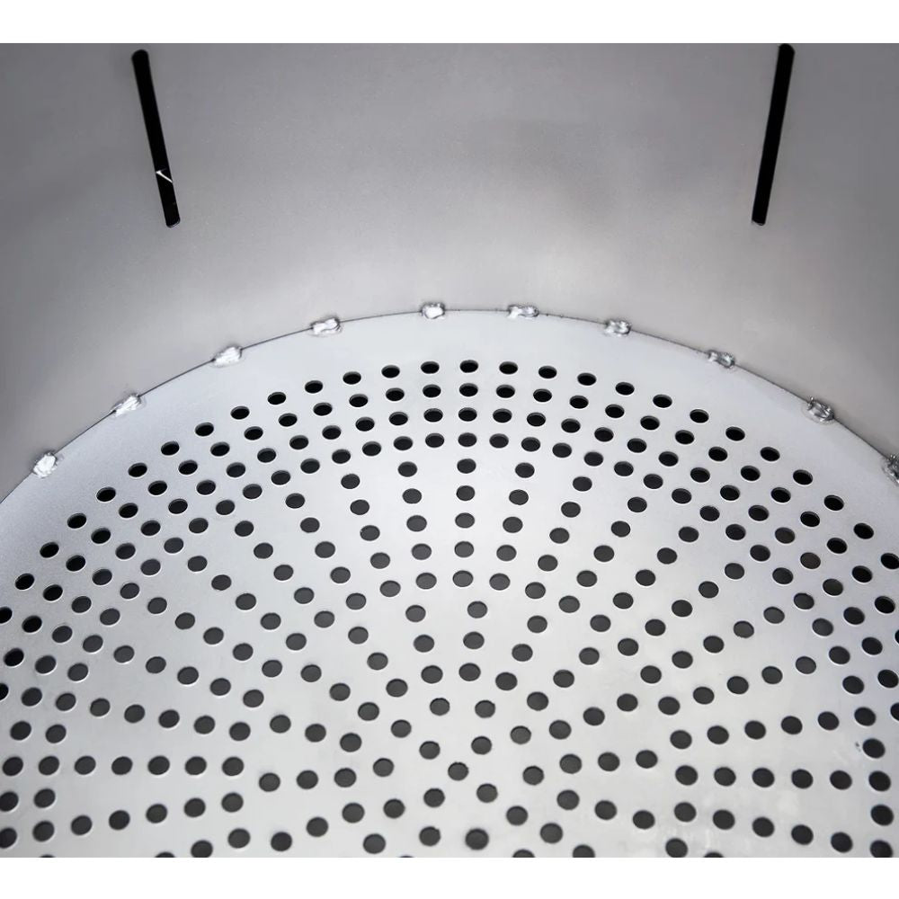 Round metallic object with perforated design on a gray background