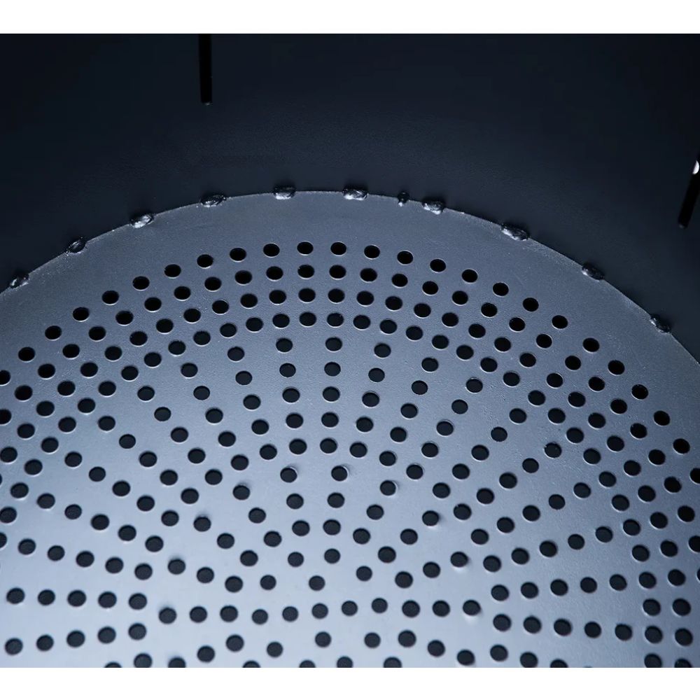 Close-up of a metallic perforated disc on a dark background