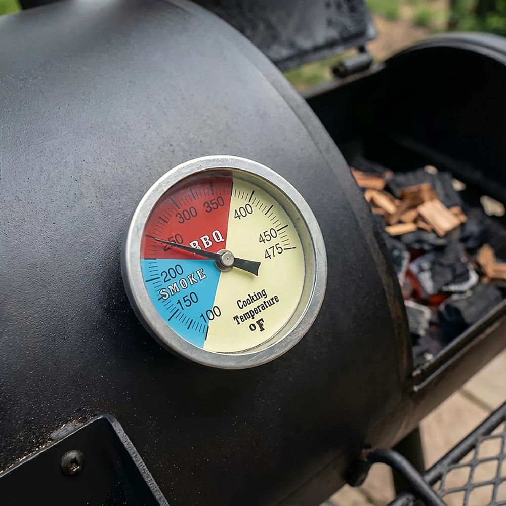 Barbecue grill with a thermometer showing temperature settings